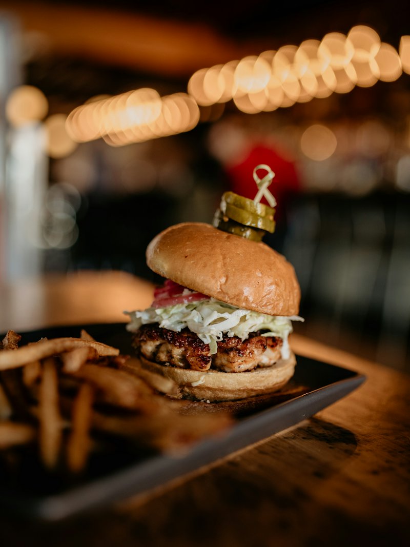 A burger with fries served on a tray